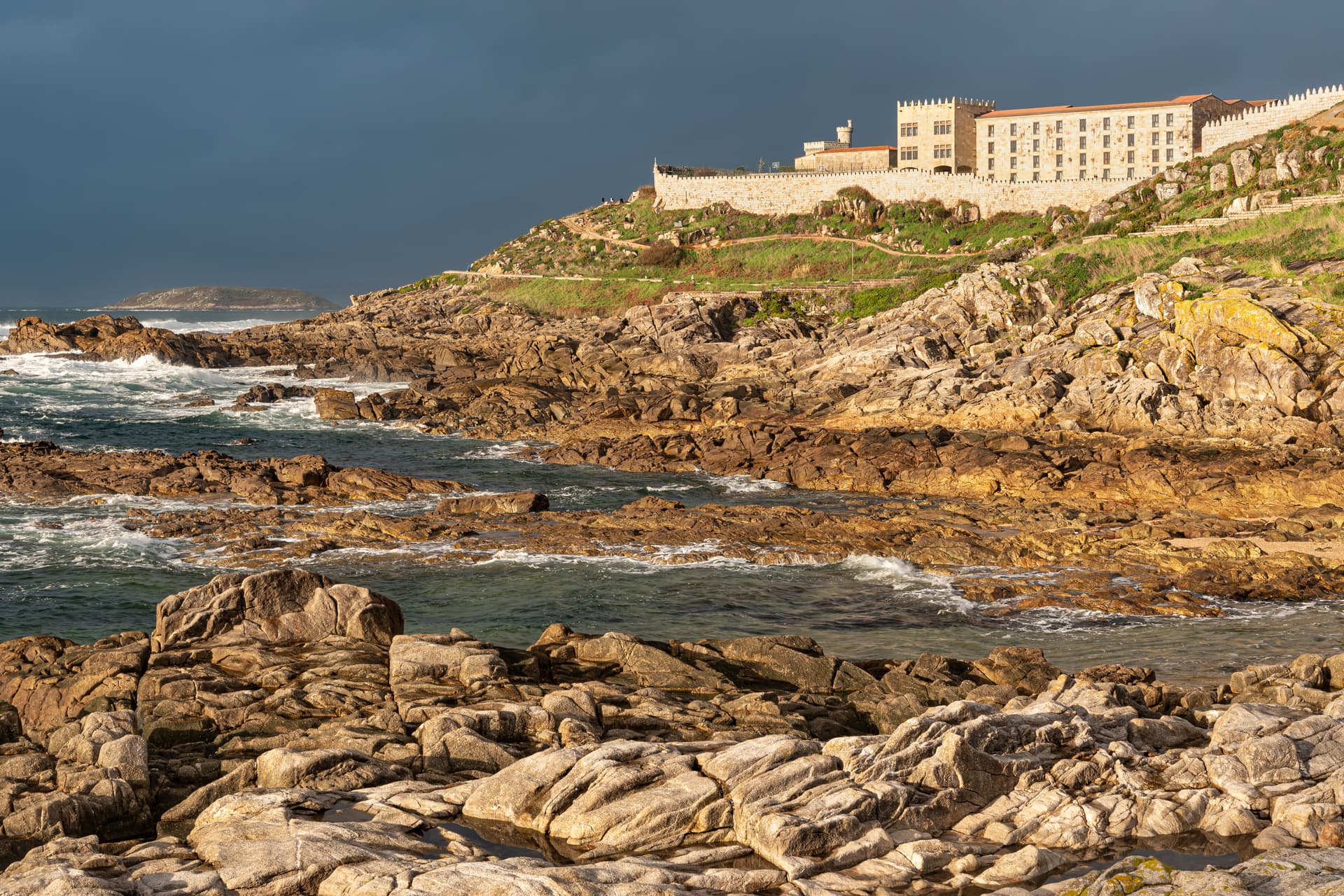The Parador and ramparts of Monterreal fortress on a rocky headland above the Atlantic at Baiona