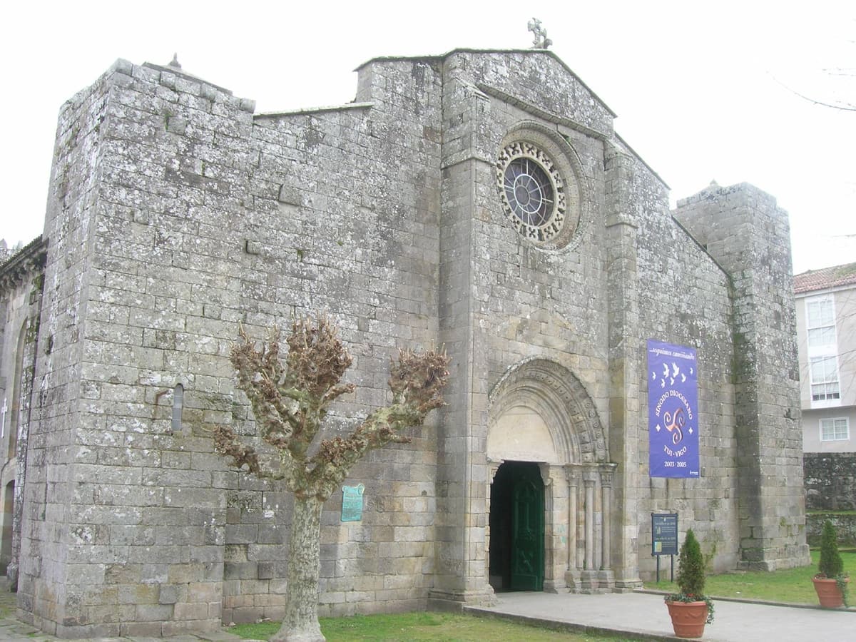 The Romanesque stone façade and rose window of the former collegiate church of Santa María in Baiona
