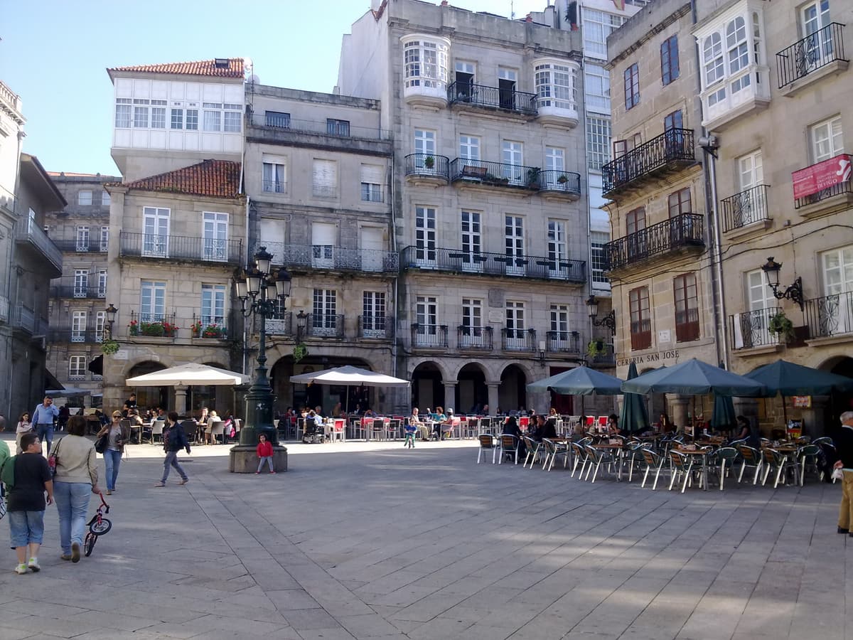 Café terraces and stone arcades in a square of Vigo’s old quarter